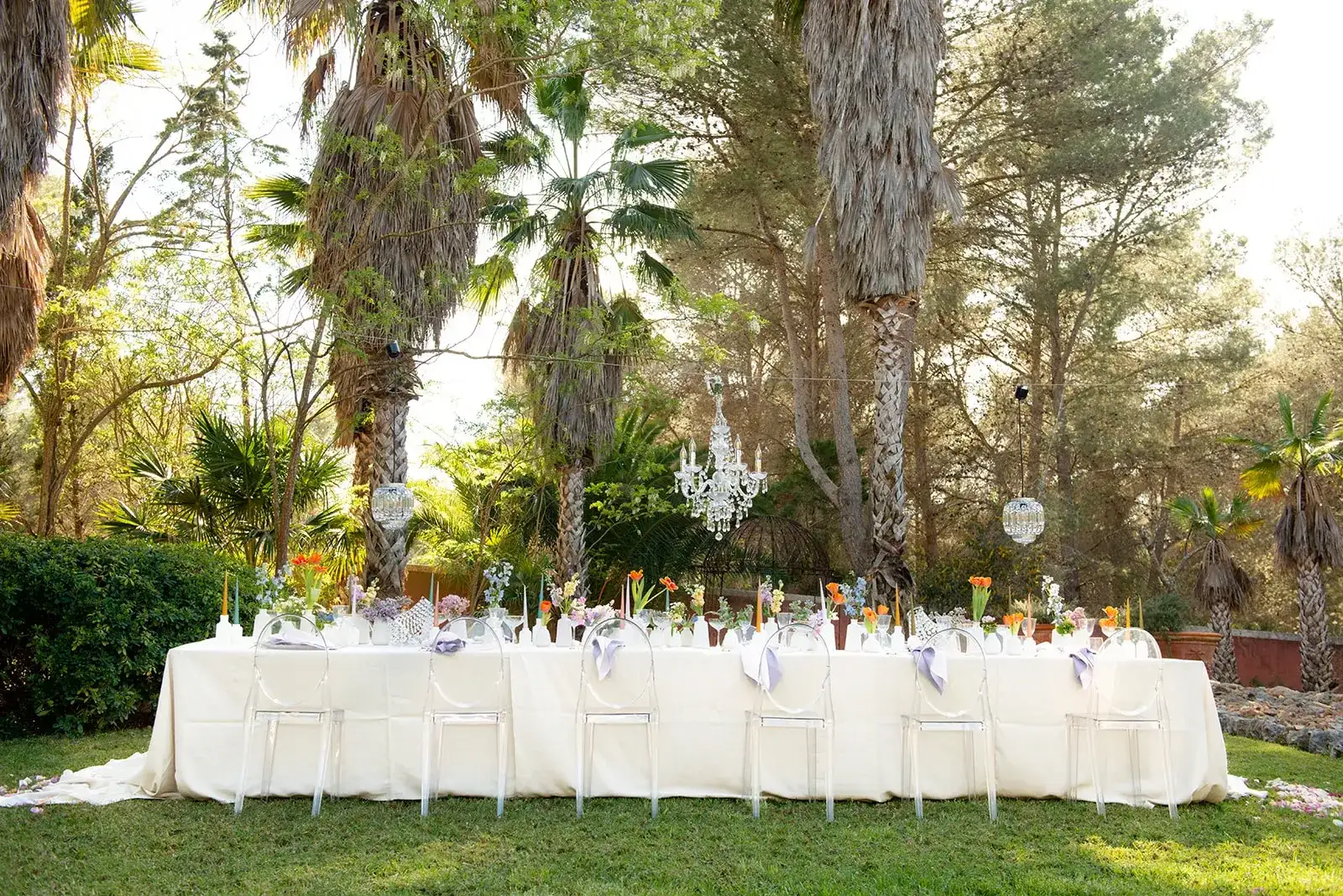 A long white table in a palm garden, spring styled shoot