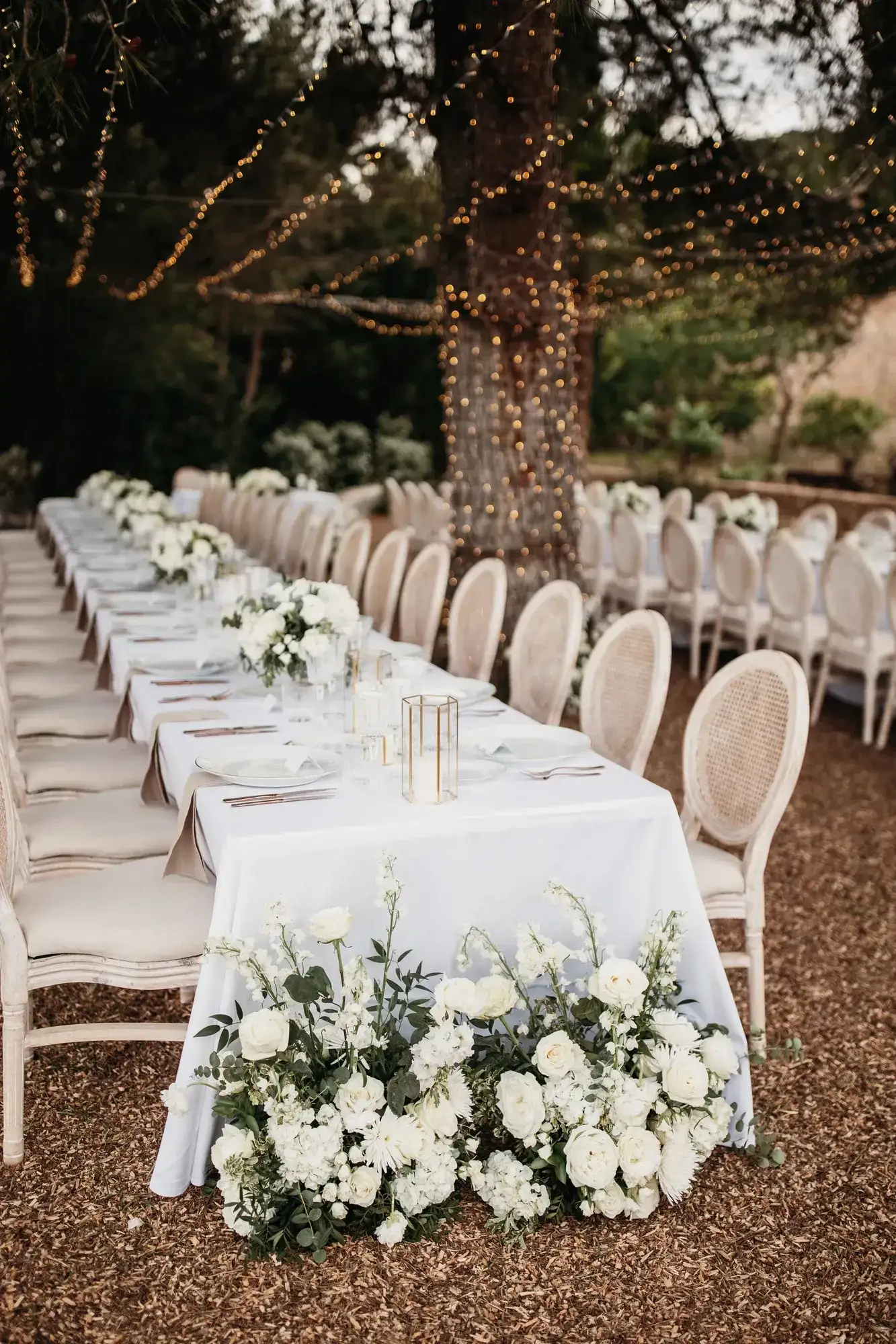 White flowers banked at the end of the table