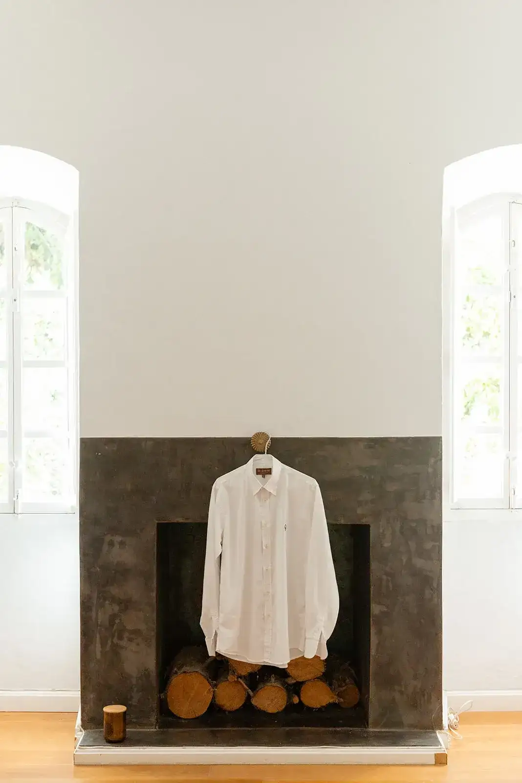 The groom's shirt hung by the fireplace, spring styled shoot