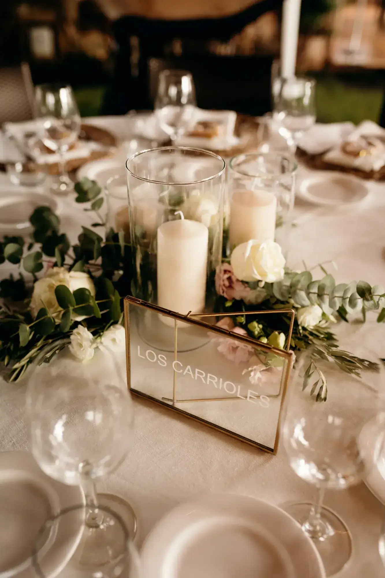 Candles and glass lanterns on round tables, Can Curreu