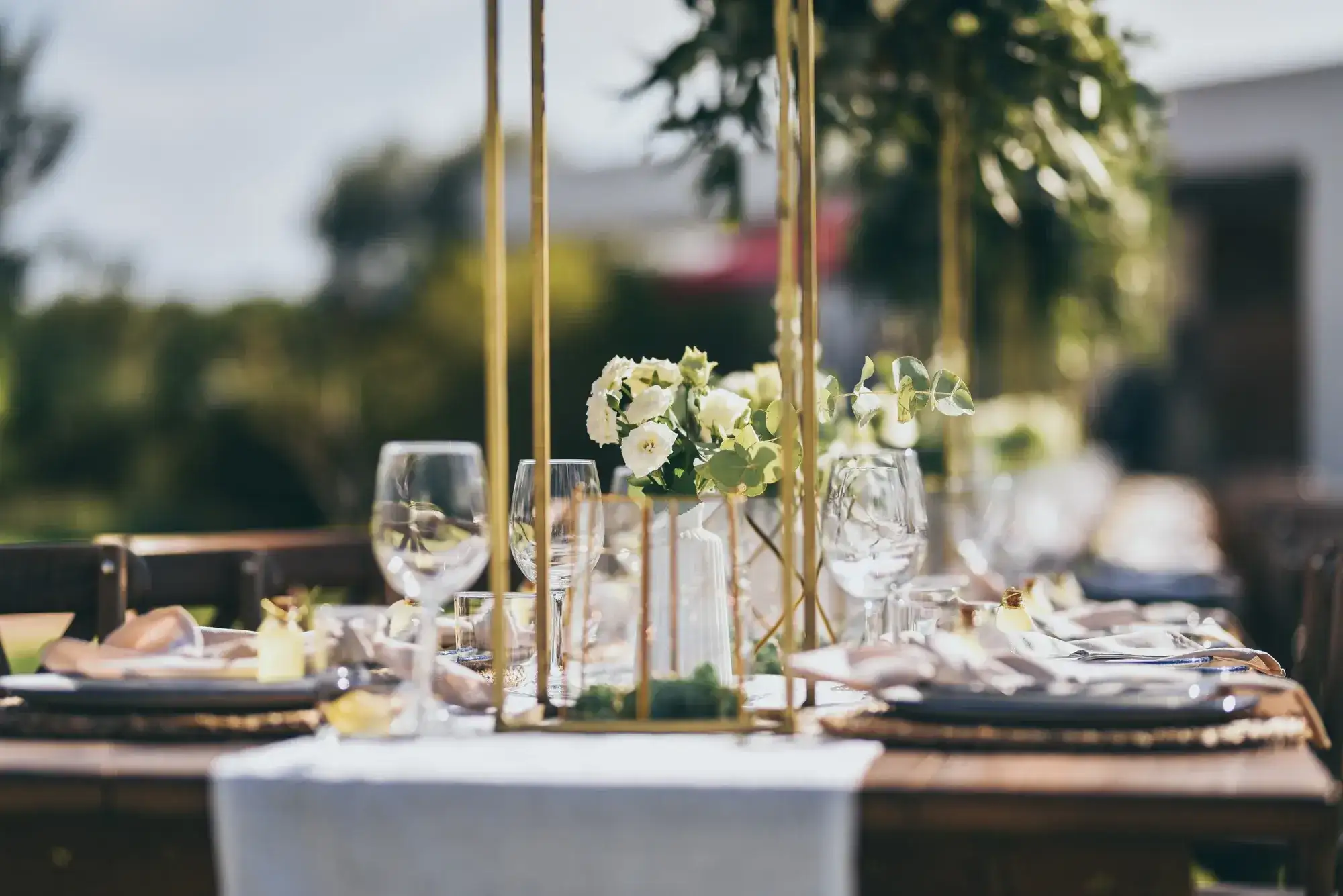 Gold stands and white flowers on the table