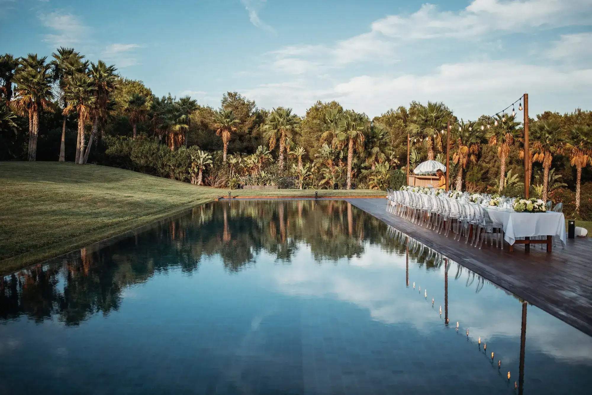 A long table beside the reflecting pool at a white Ibiza villa