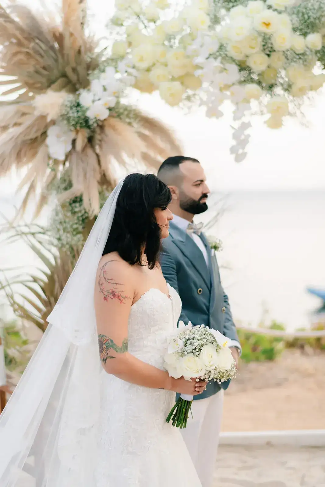 Bride and groom with a white bouquet, Nikki Beach Ibiza
