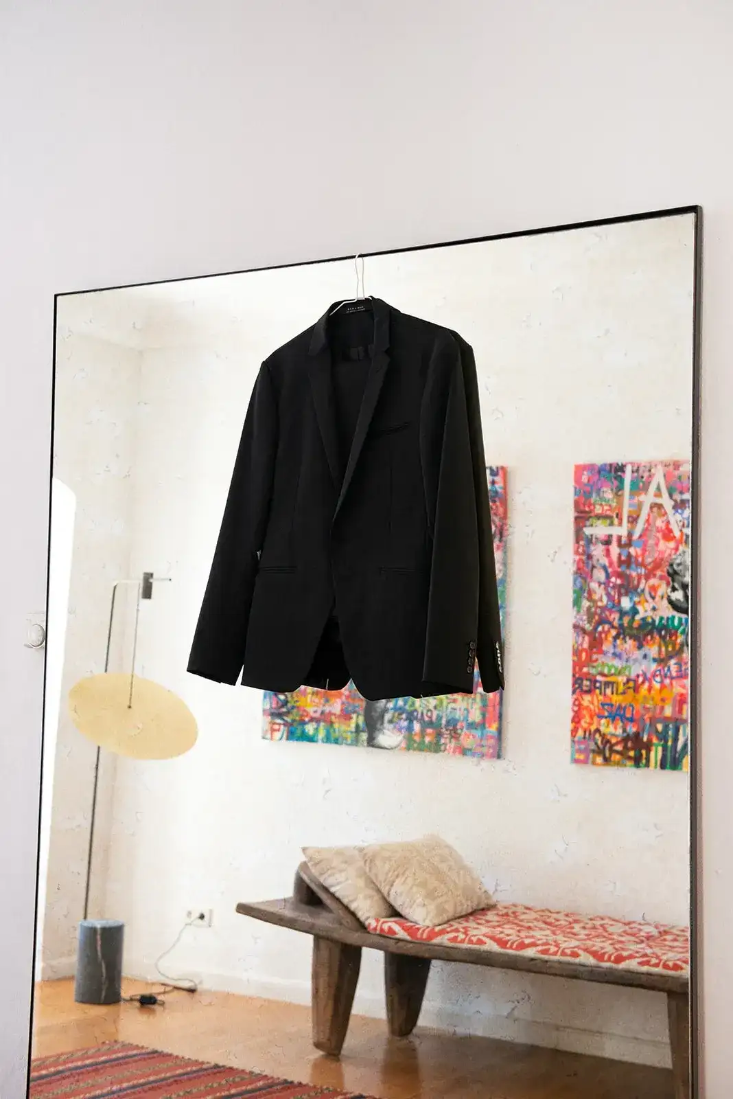 The groom's jacket in a white room, spring styled shoot