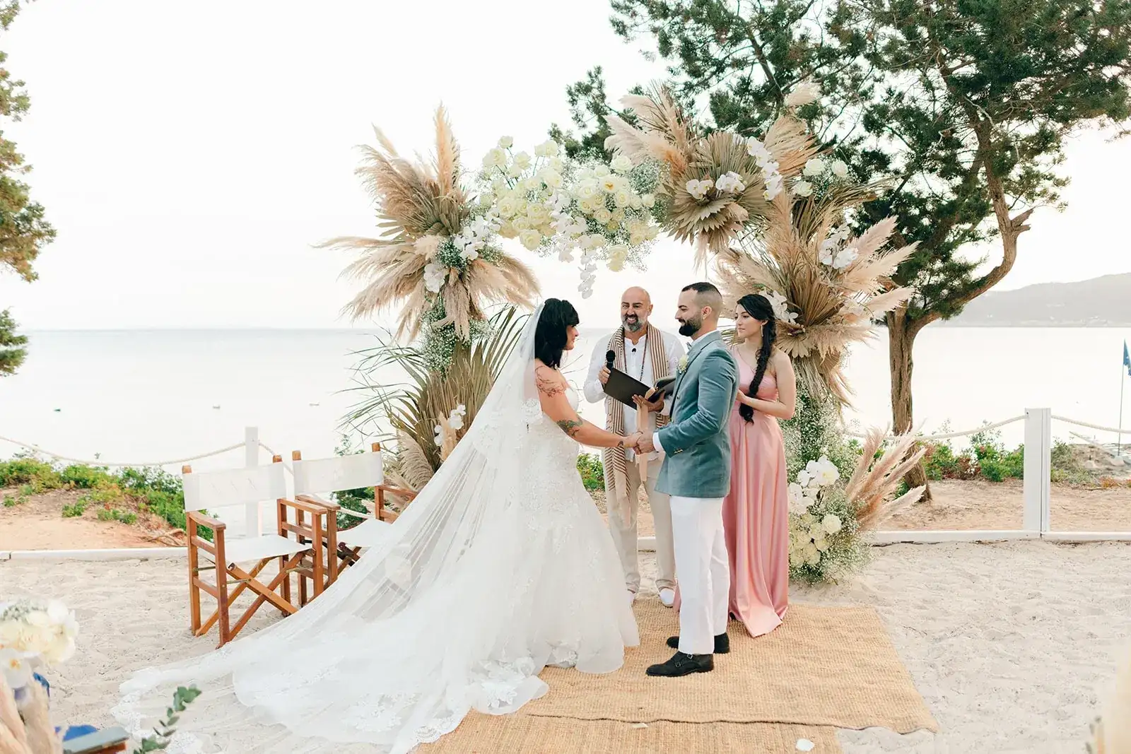 A beach ceremony under a pampas arch at Nikki Beach Ibiza