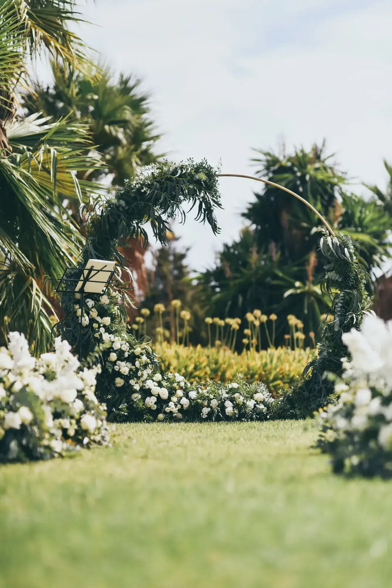 A green hoop arch at the end of the lawn