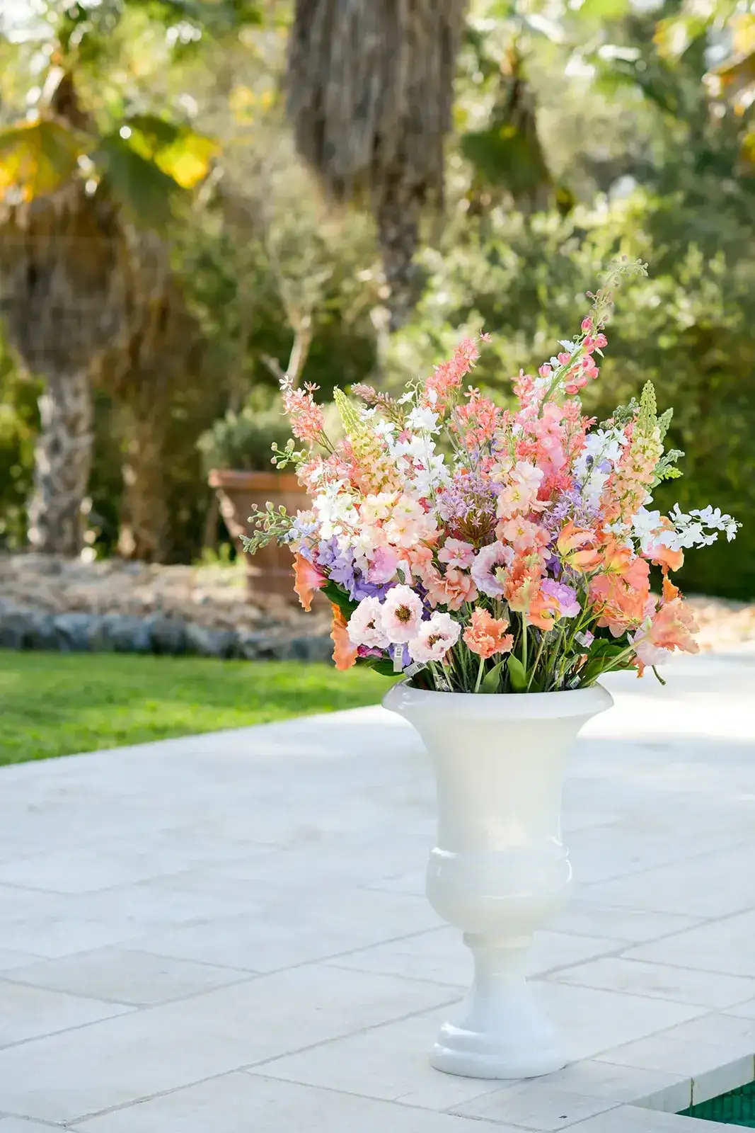 A pastel arrangement in a white urn, spring styled shoot