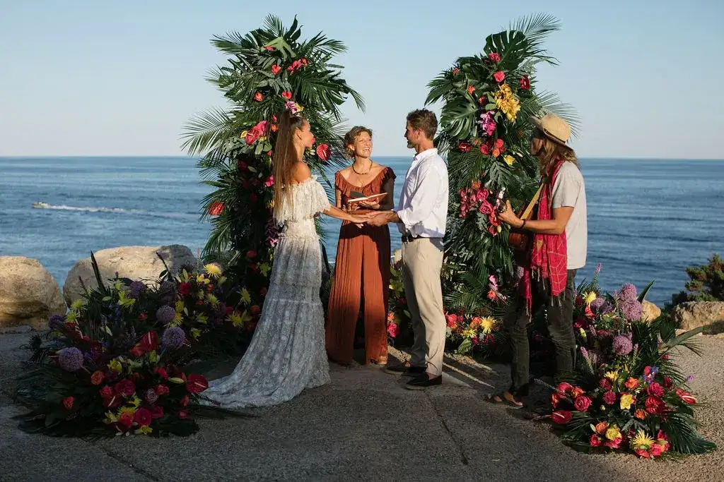 Vows between tropical flower columns above the sea