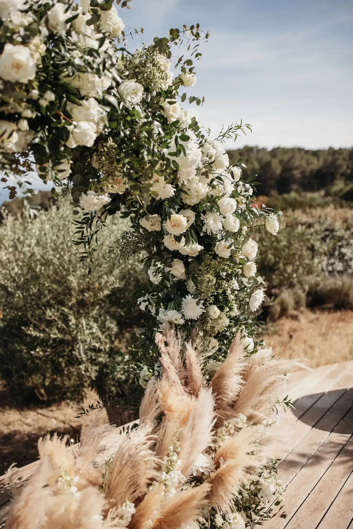 White roses and pampas along the aisle