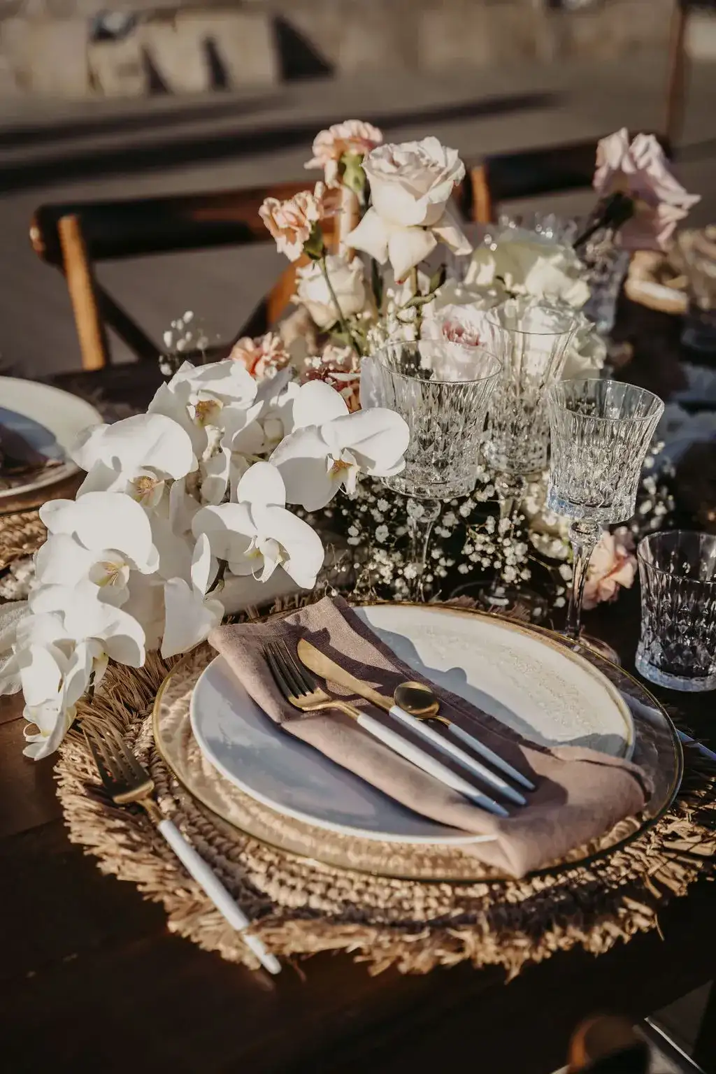 White orchids and gold cutlery on rattan