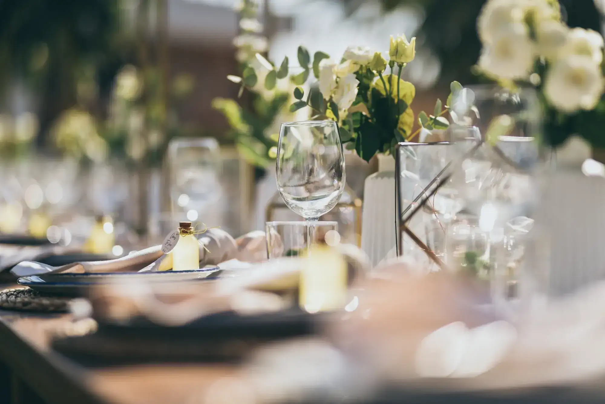 Small white flowers and crystal along the table