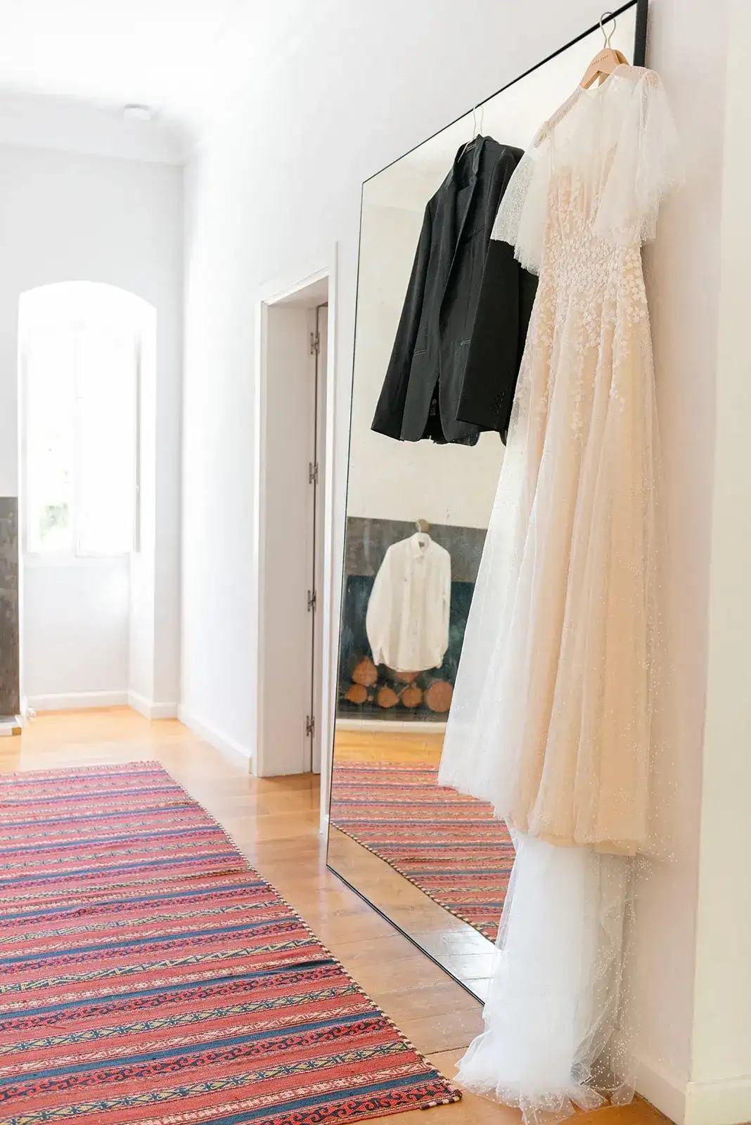 The dress and suit hanging in a white bedroom, spring styled shoot