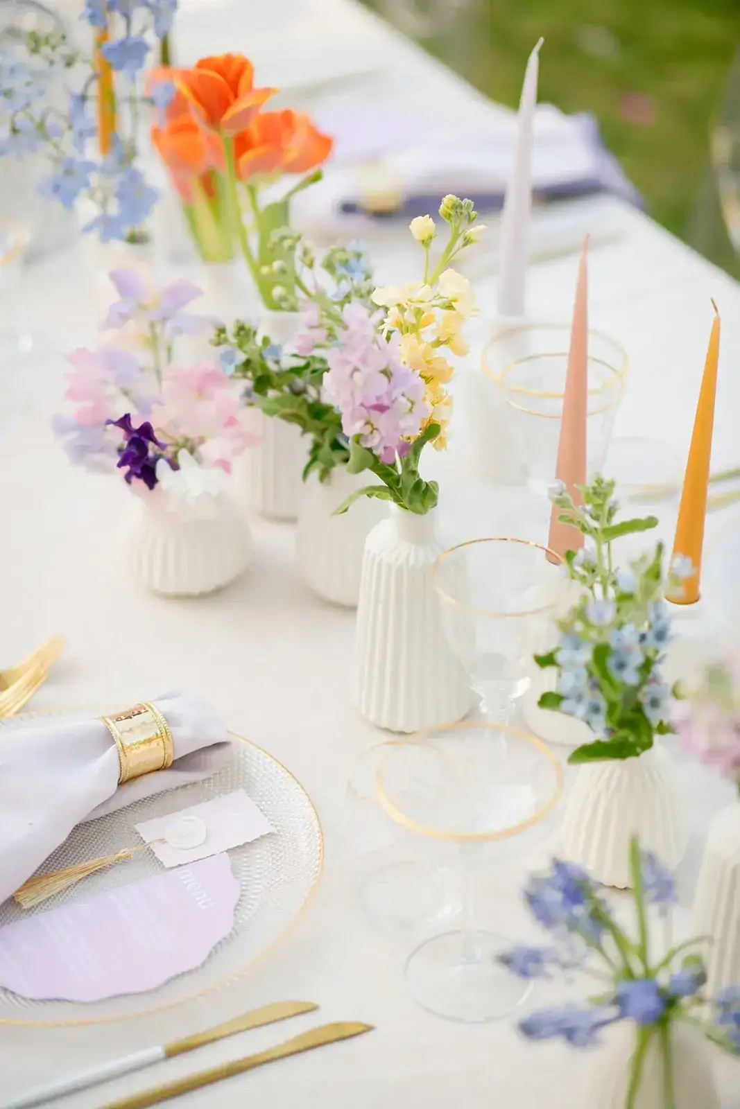 Pastel bud vases and coloured taper candles, spring styled shoot
