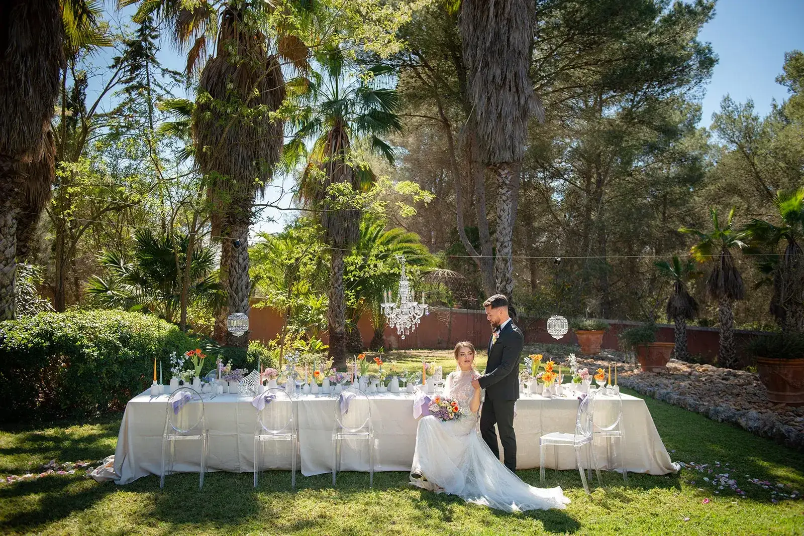 The couple beside a garden table, spring styled shoot