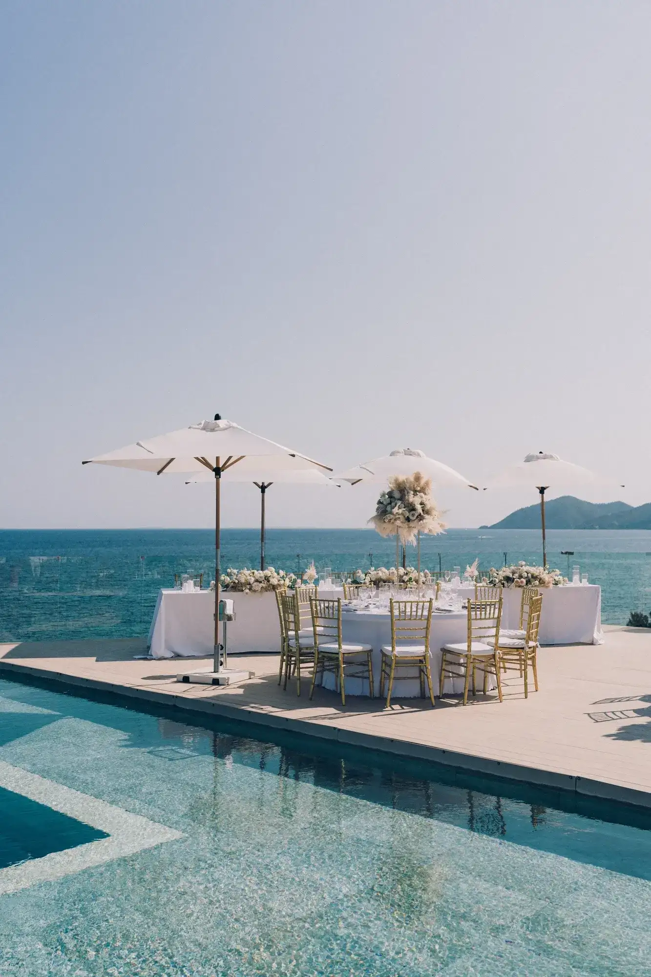 Dinner set on a pool deck by the sea, ME Ibiza
