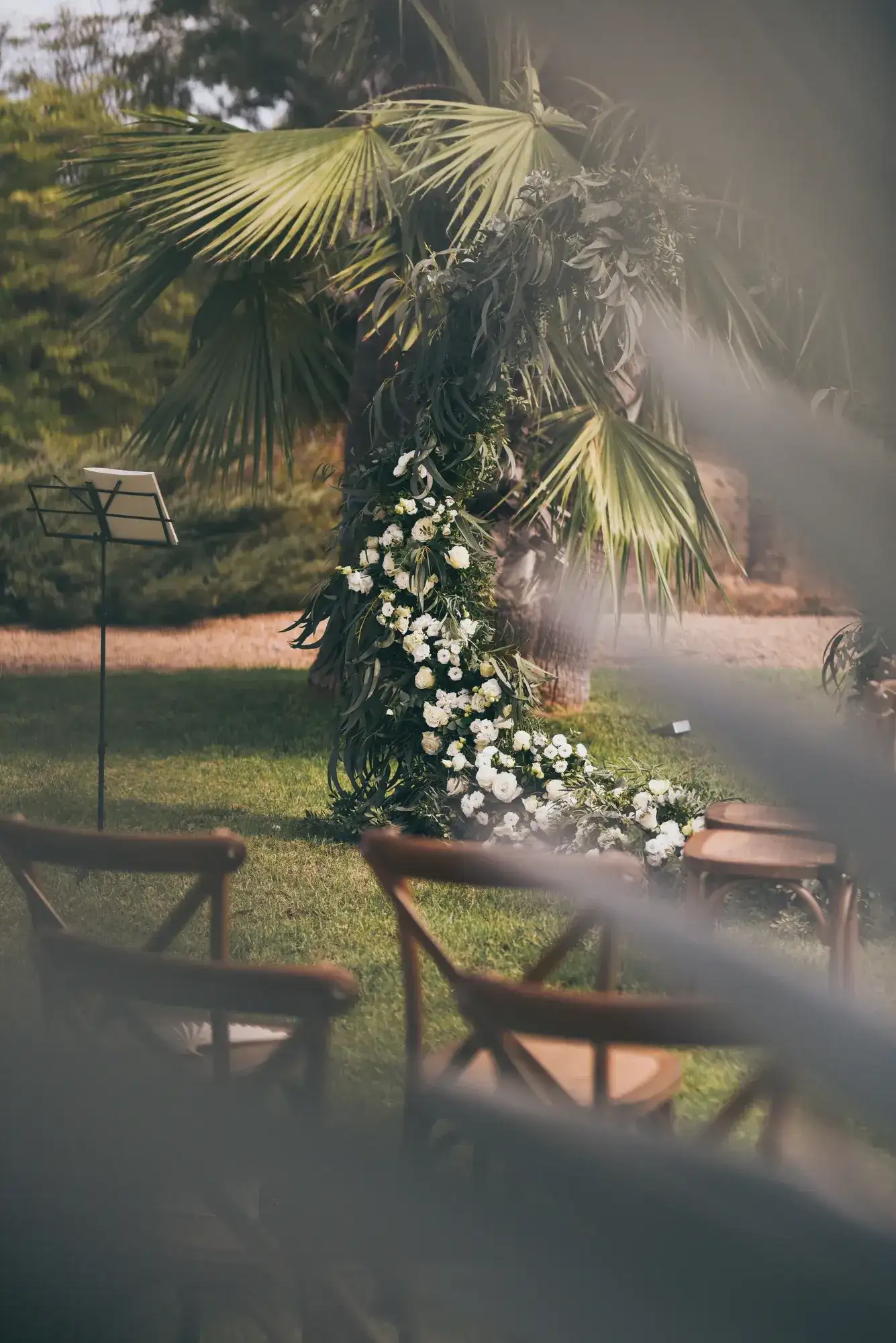 A floral arch beyond the palms
