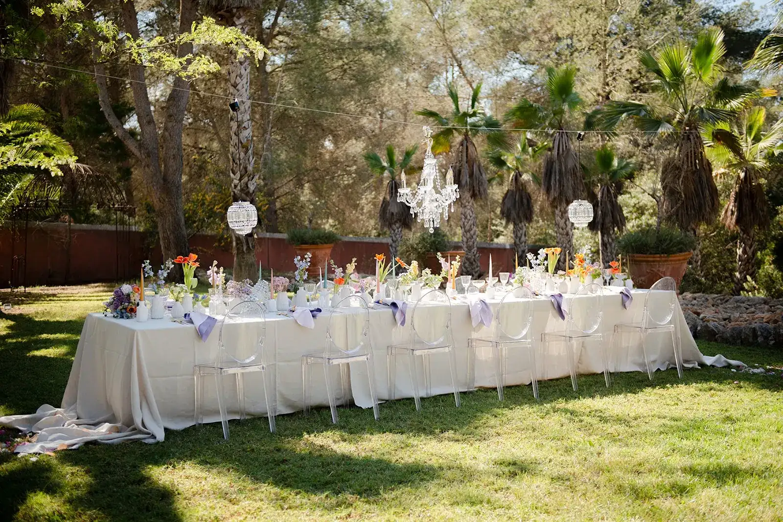 A long table set in a palm garden, spring styled shoot