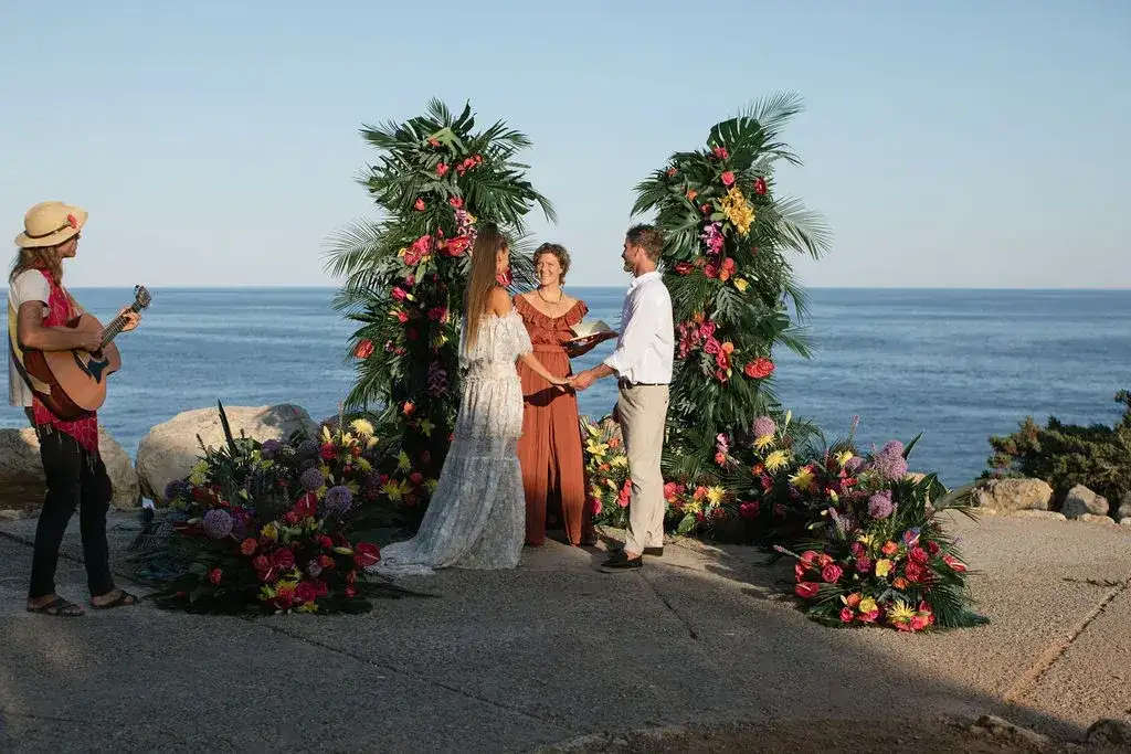 Tropical flower columns for a clifftop ceremony above the sea