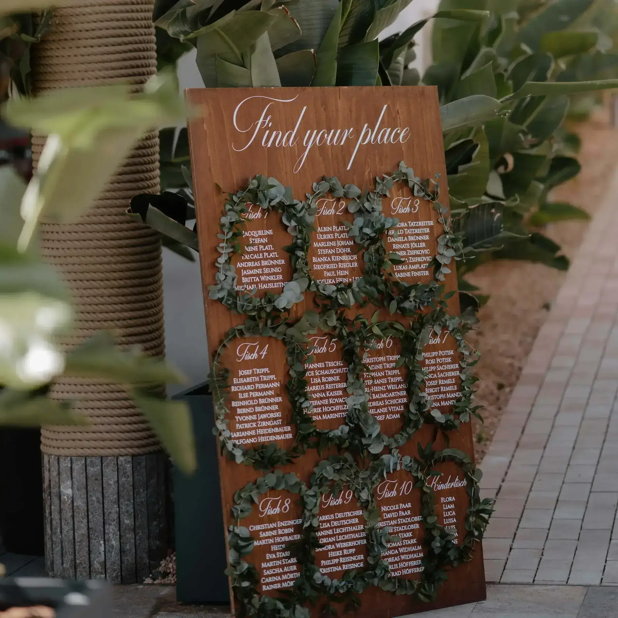 7Pines Resort Ibiza: Wooden 'find your place' seating-plan board with greenery