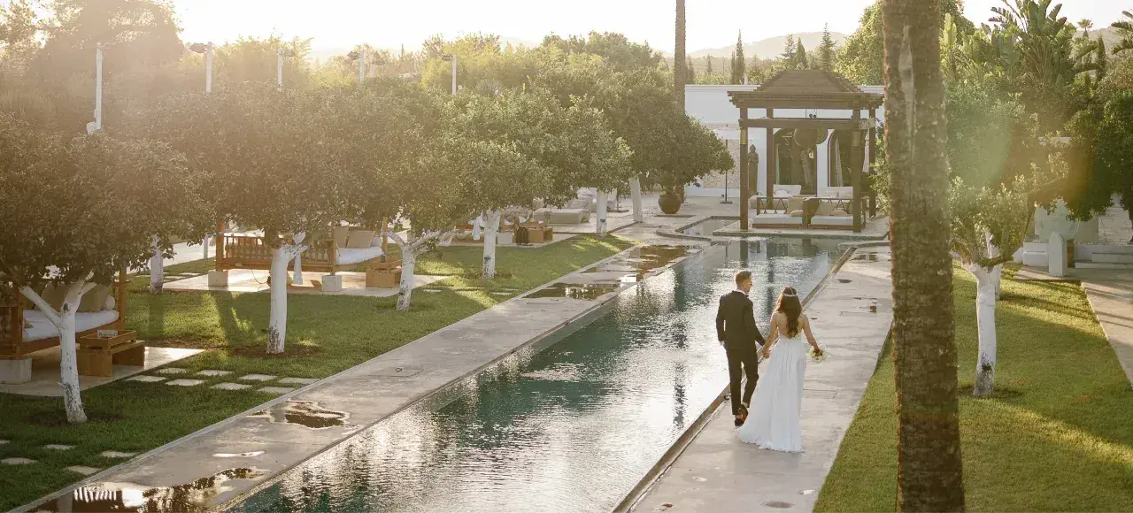 Agroturismo Atzaró: Bride and groom walking beside the long garden pool