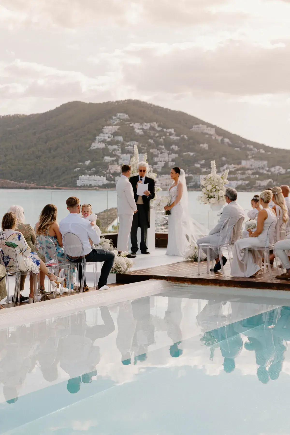Rooftop wedding ceremony by the pool at Aguas de Ibiza, with the bay behind