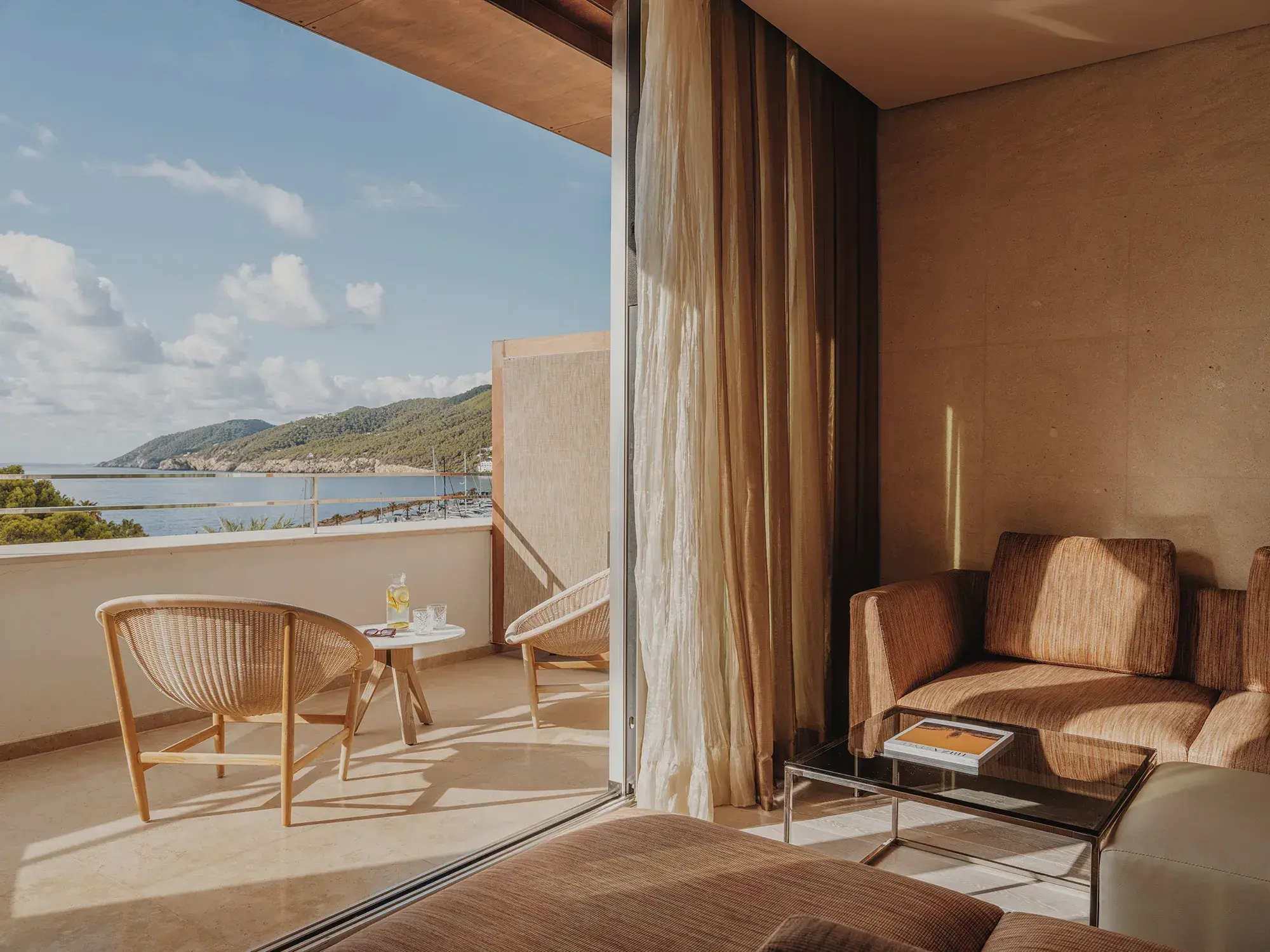 Aguas de Ibiza: Suite lounge opening onto a terrace with sea and hill views