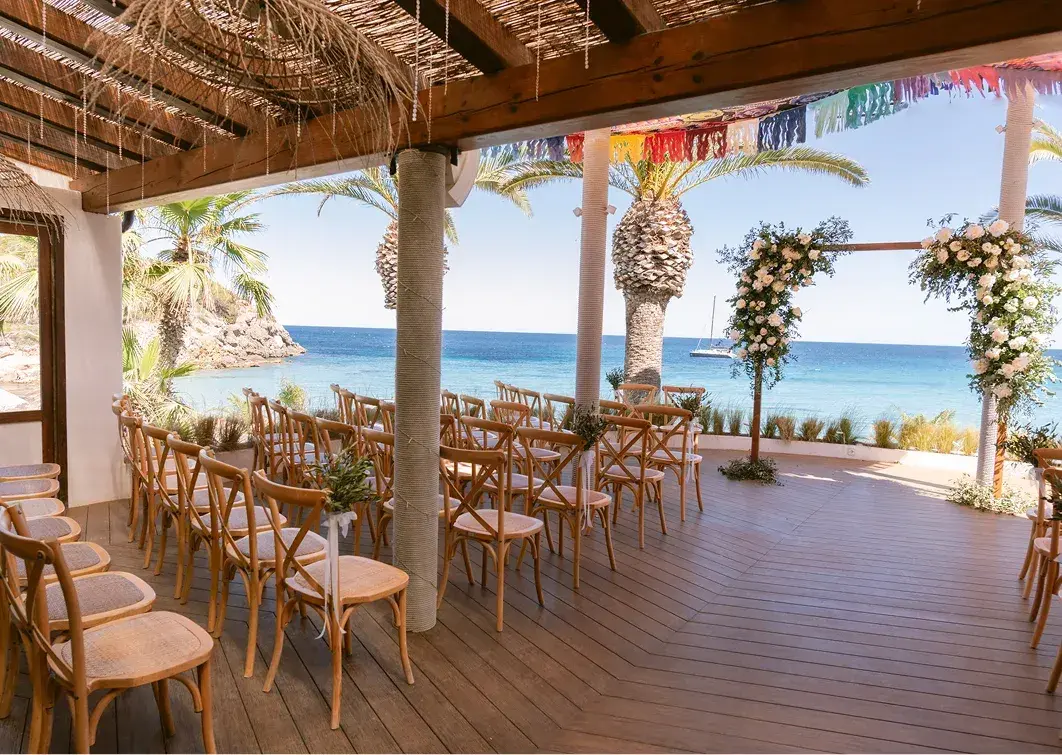 Aiyanna Ibiza: Rows of ceremony chairs facing a floral arch on the covered terrace