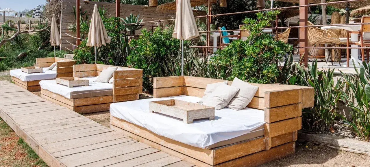 Atzaró Beach: Daybeds set among plants on the beach terrace