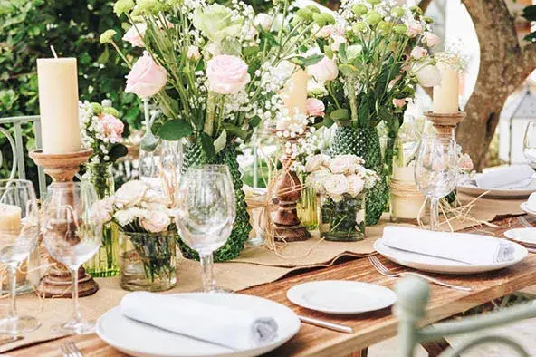 Aubergine by Atzaró: Wedding table with candles, flowers and white napkins