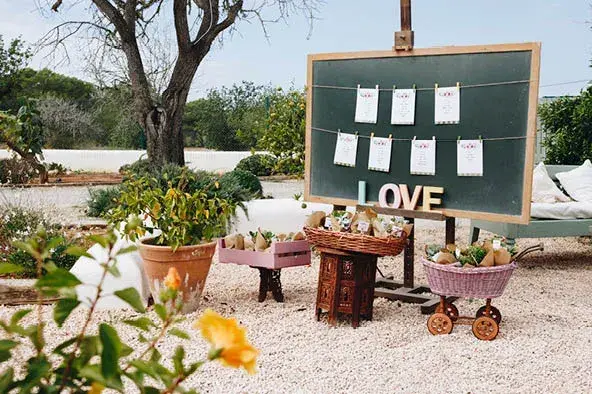 Aubergine by Atzaró: Seating-plan chalkboard reading LOVE in the garden