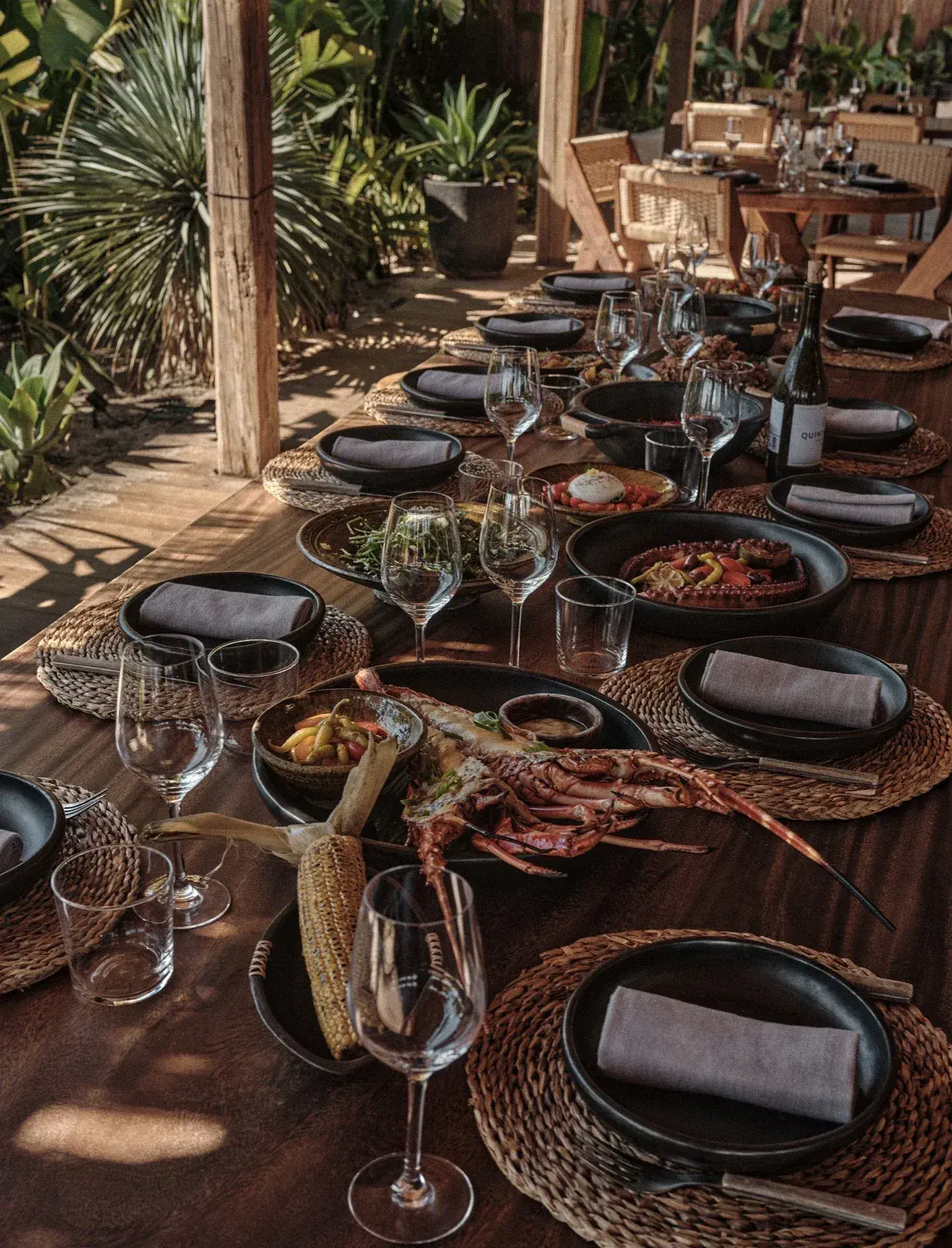 Beachouse Ibiza: Long wooden table set for a group sharing feast with seafood