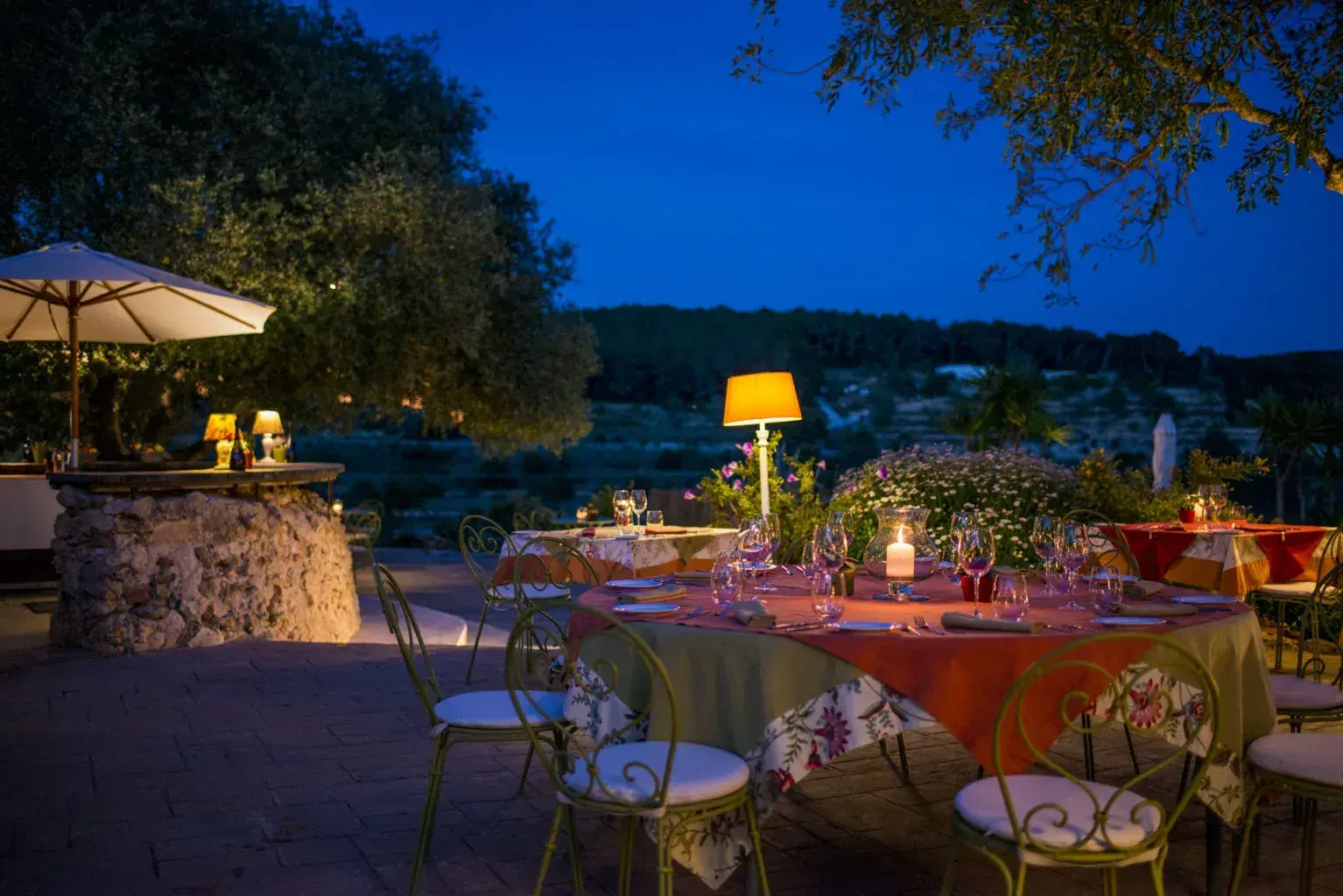 Can Domingo: Terrace tables with orange cloths looking over the valley