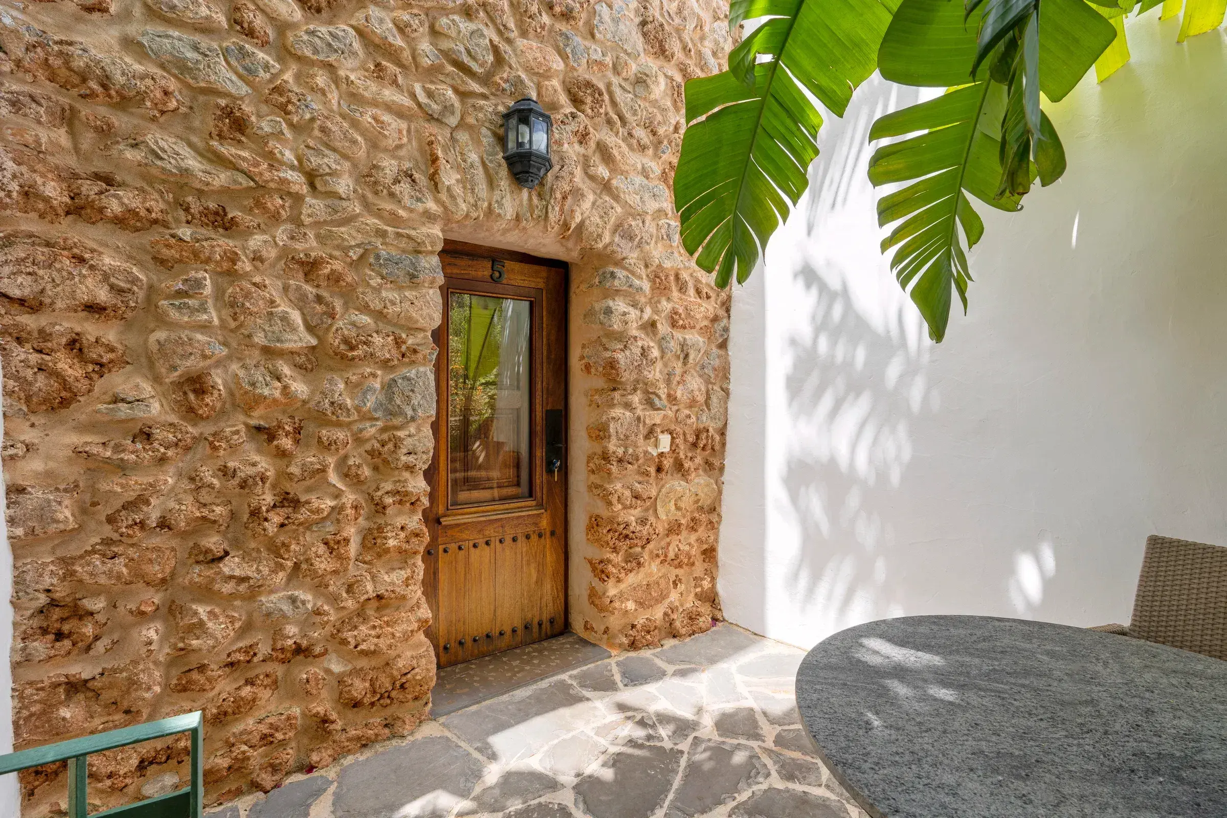 Can Gall: Stone wall and wooden door of a terrace room