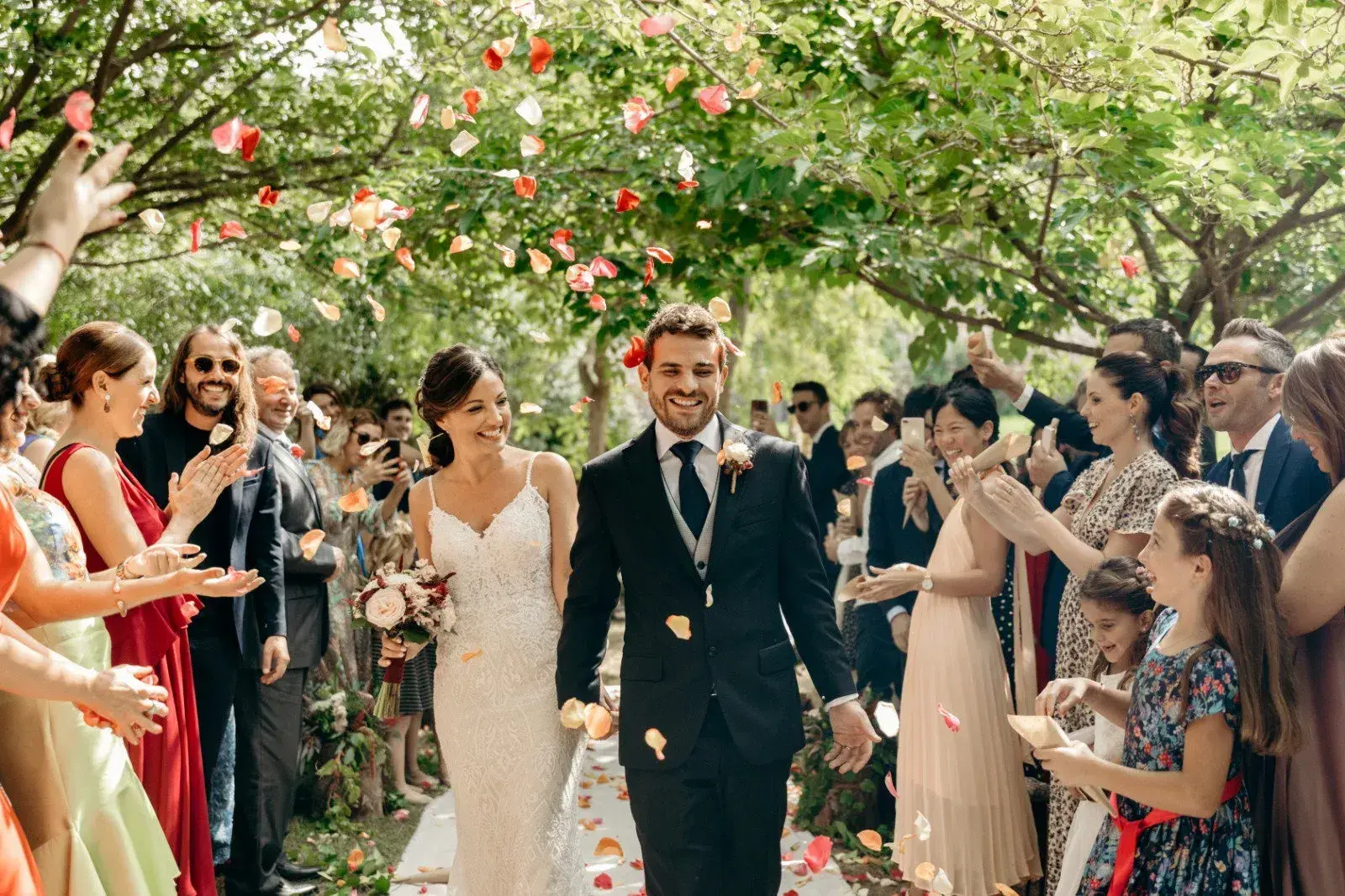 Can Lluc: Couple leaving the ceremony under a shower of petals