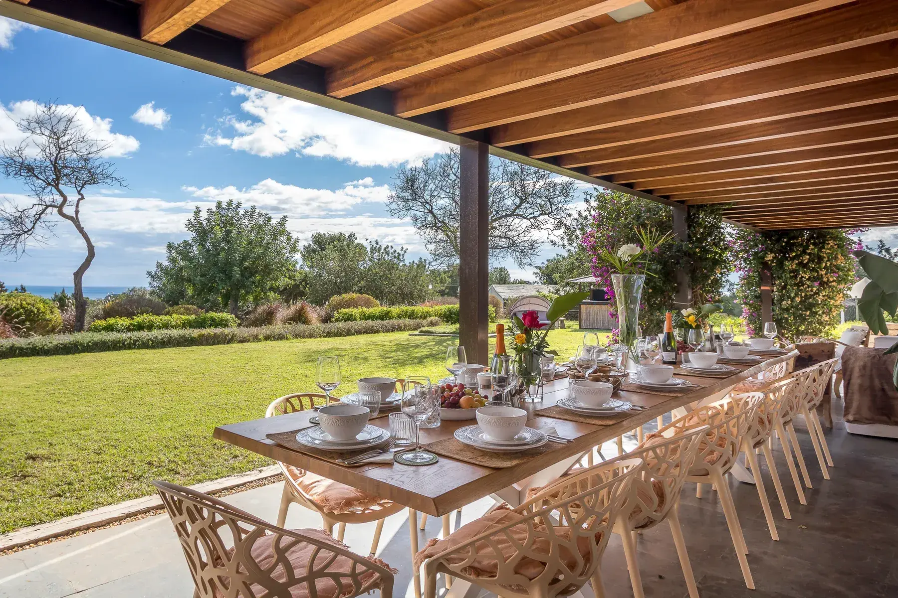 Wedding table set under a pergola with garden views at Can Skye