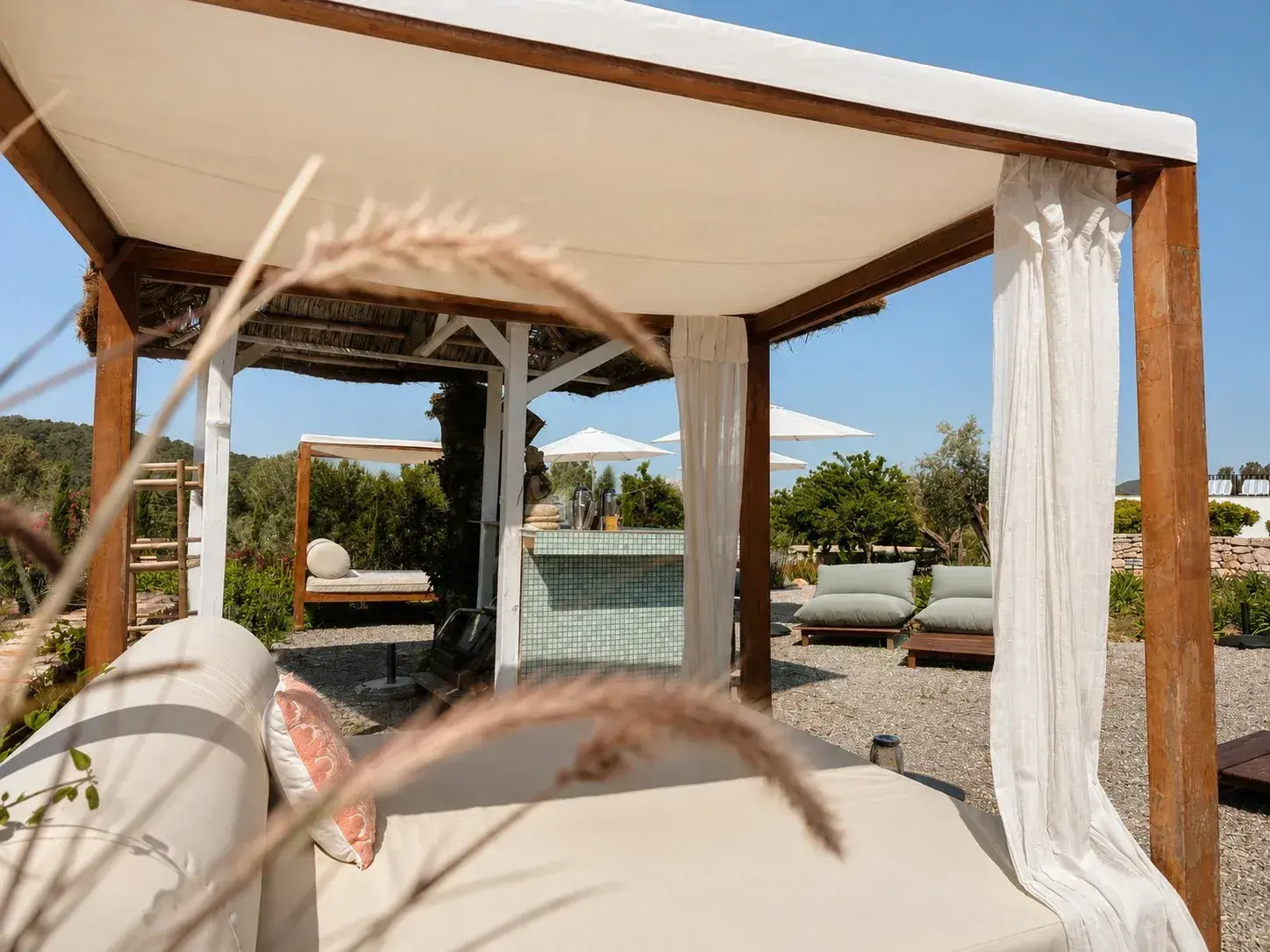 Can Skye Ibiza: Daybed under a canopy with the pool garden behind