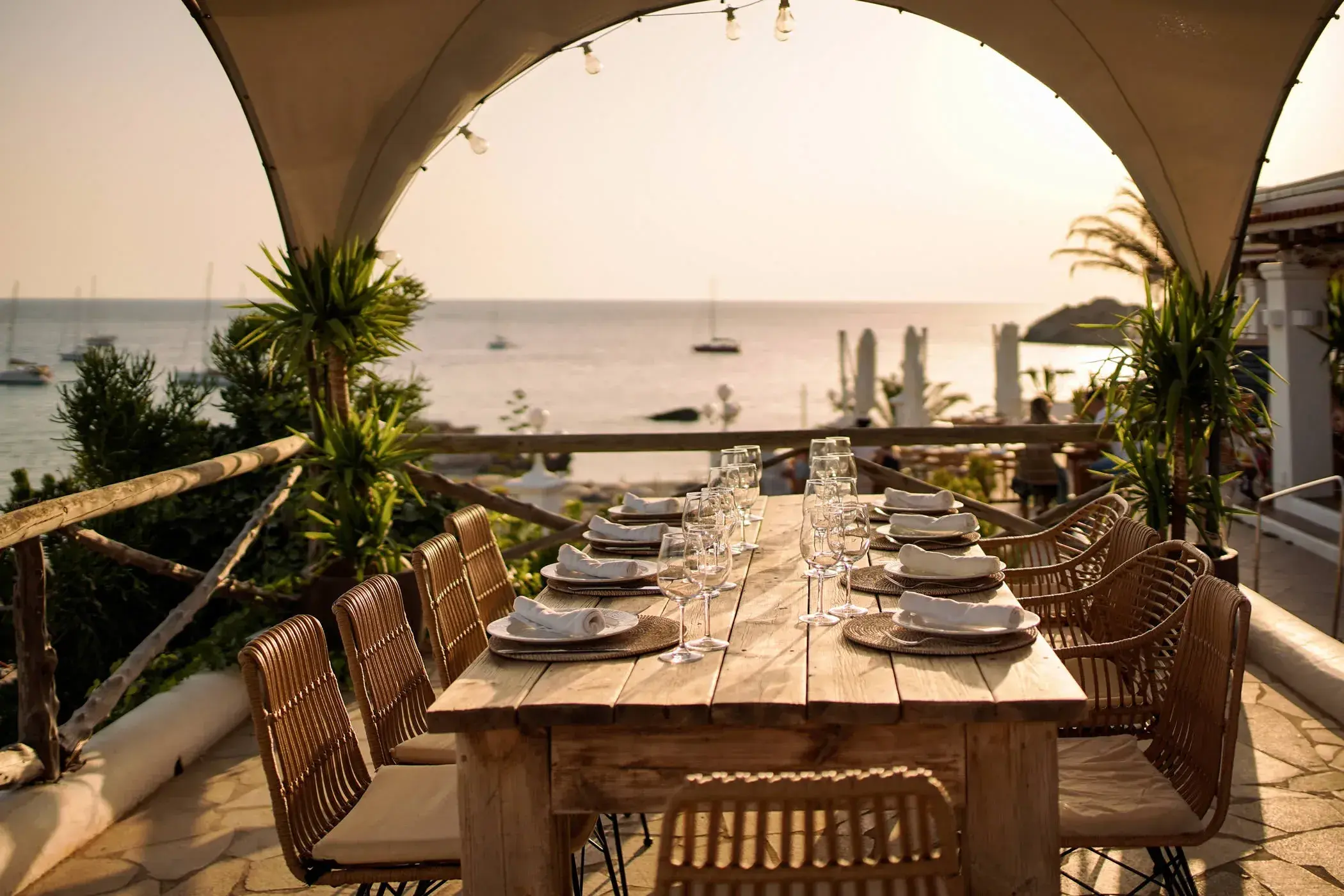 Cas Milà: Long table under a canvas arch facing the bay