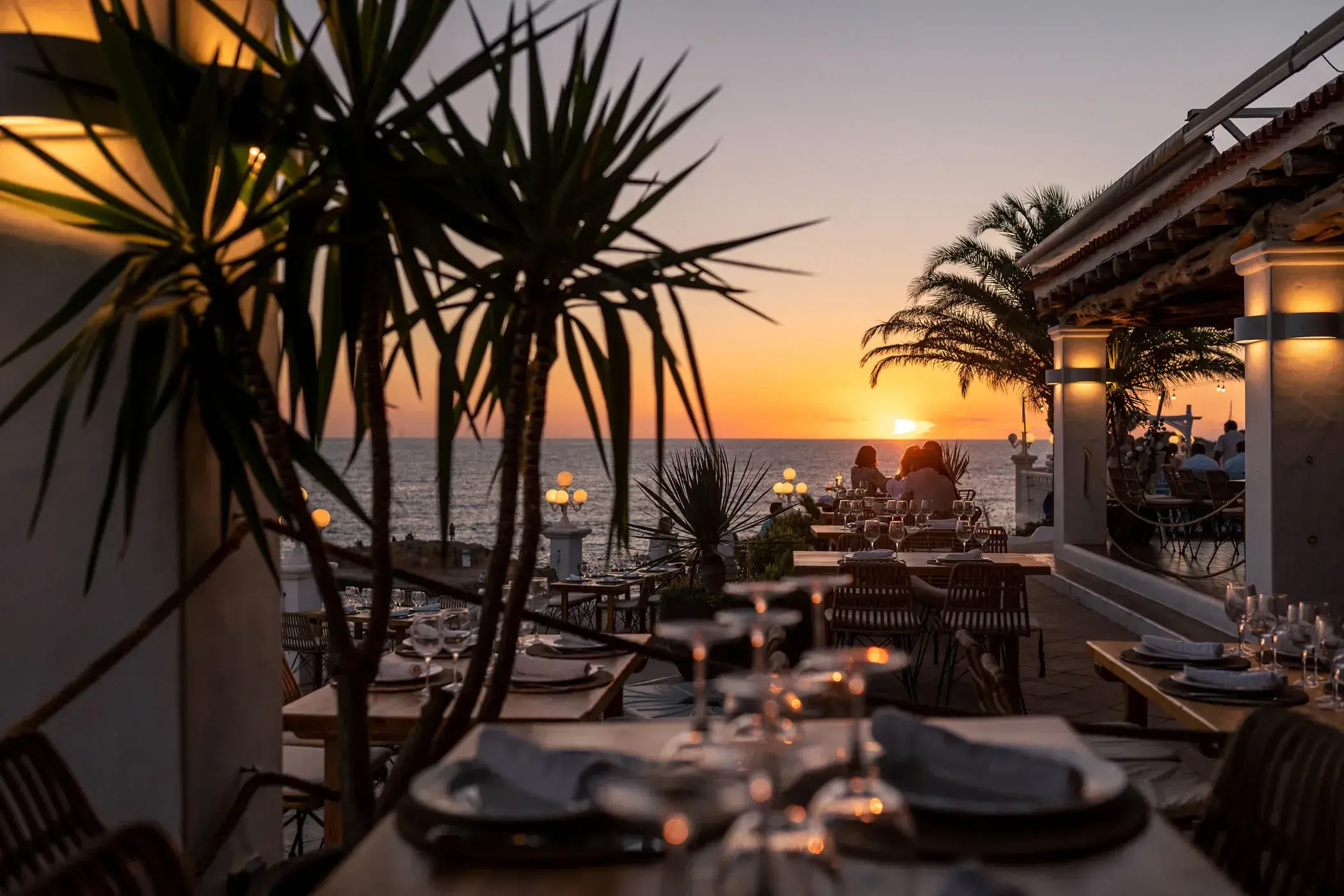 Cas Milà: Palm-lined terrace at sunset