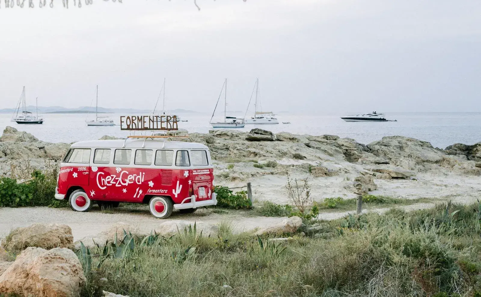 Chezz Gerdi: Rocky shore at Es Pujols with the restaurant's camper van