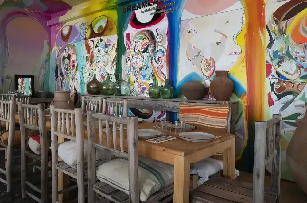 El Silencio: Covered restaurant with colourful artist murals and set tables