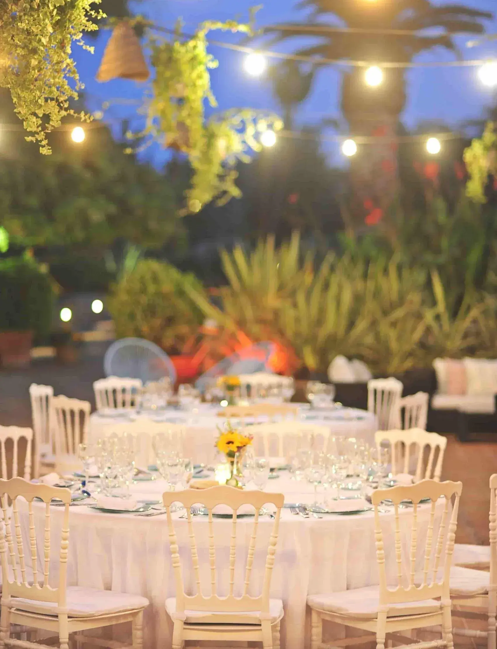 Es Jardins de Fruitera: Evening event tables under festoon lights in the garden