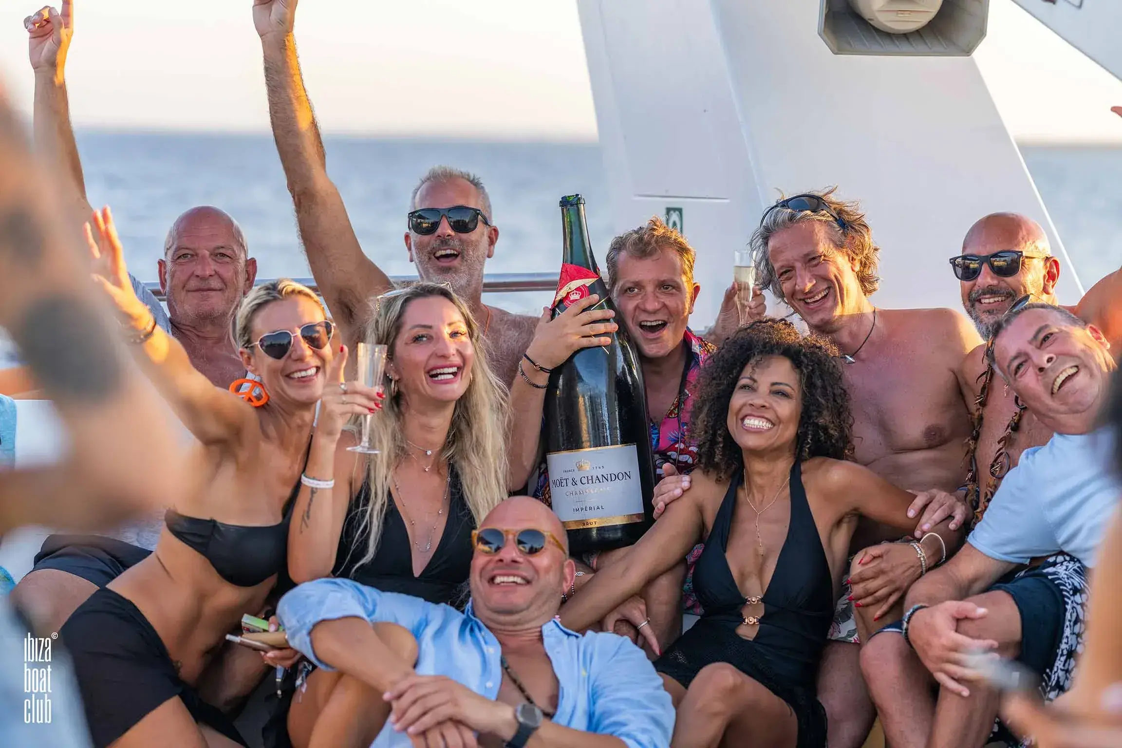 Ibiza Boat Club: Group of guests celebrating with champagne on deck
