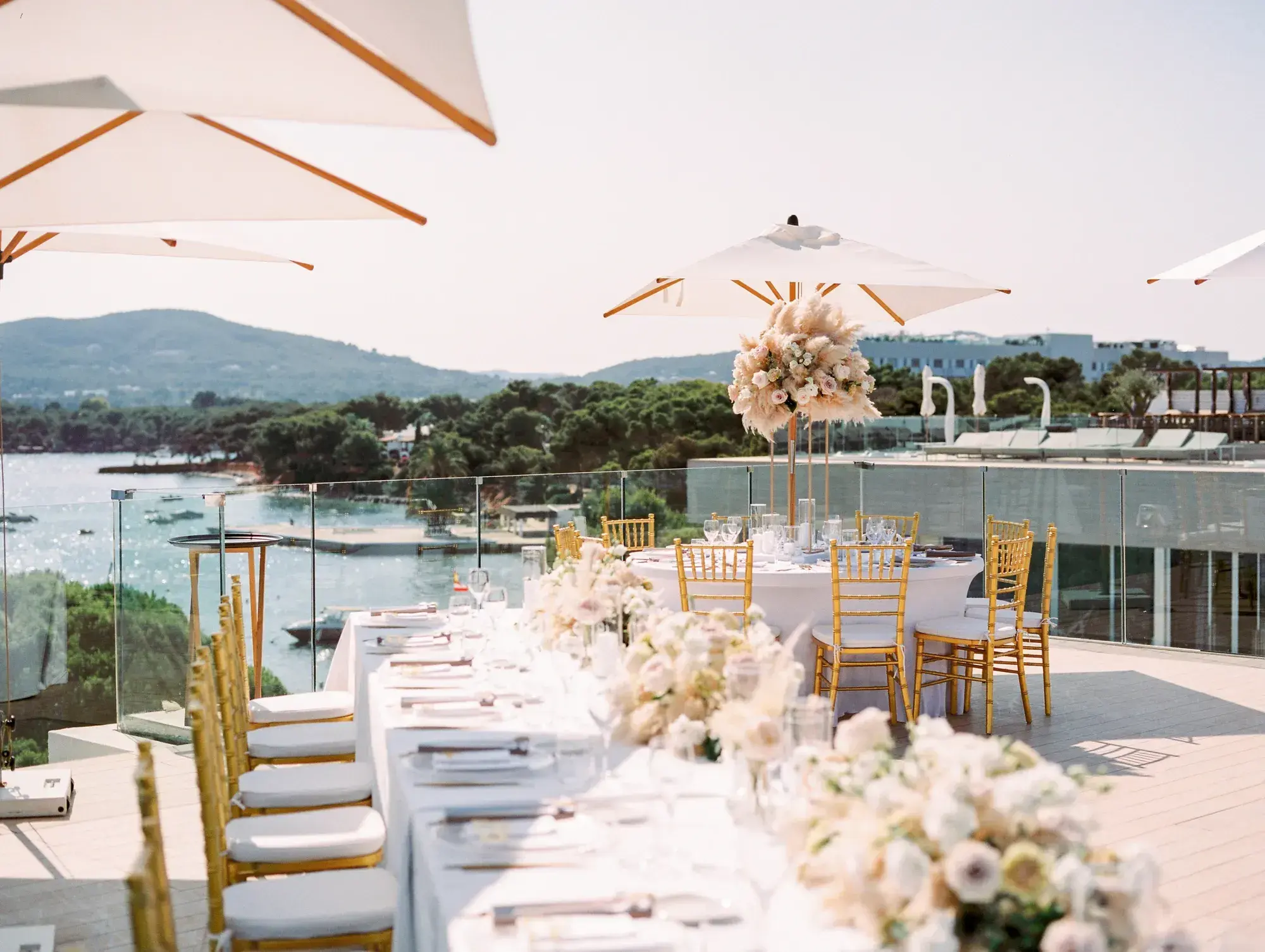 White flowers along a terrace table above the marina, ME Ibiza