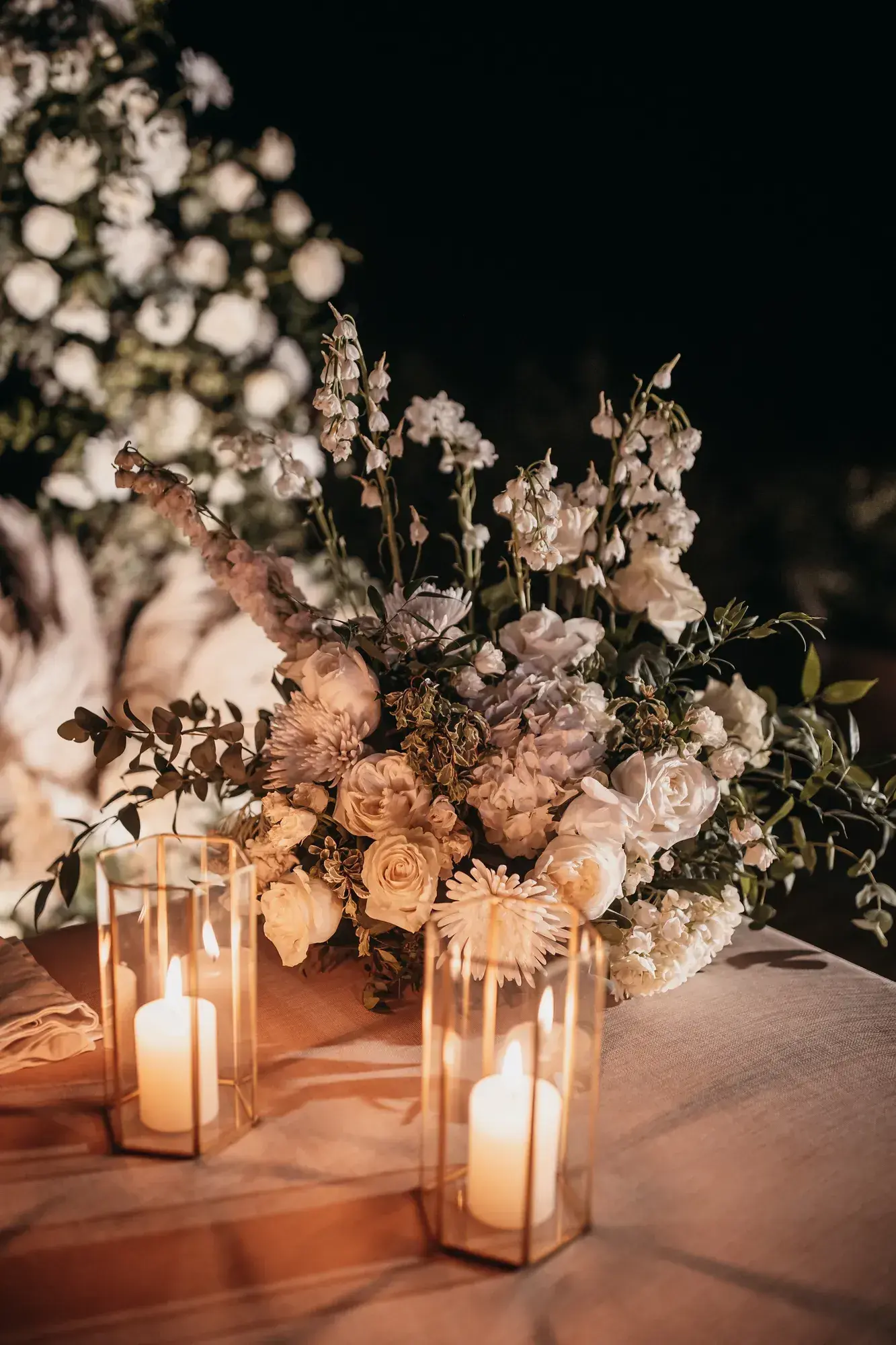 Lanterns and white flowers by candlelight