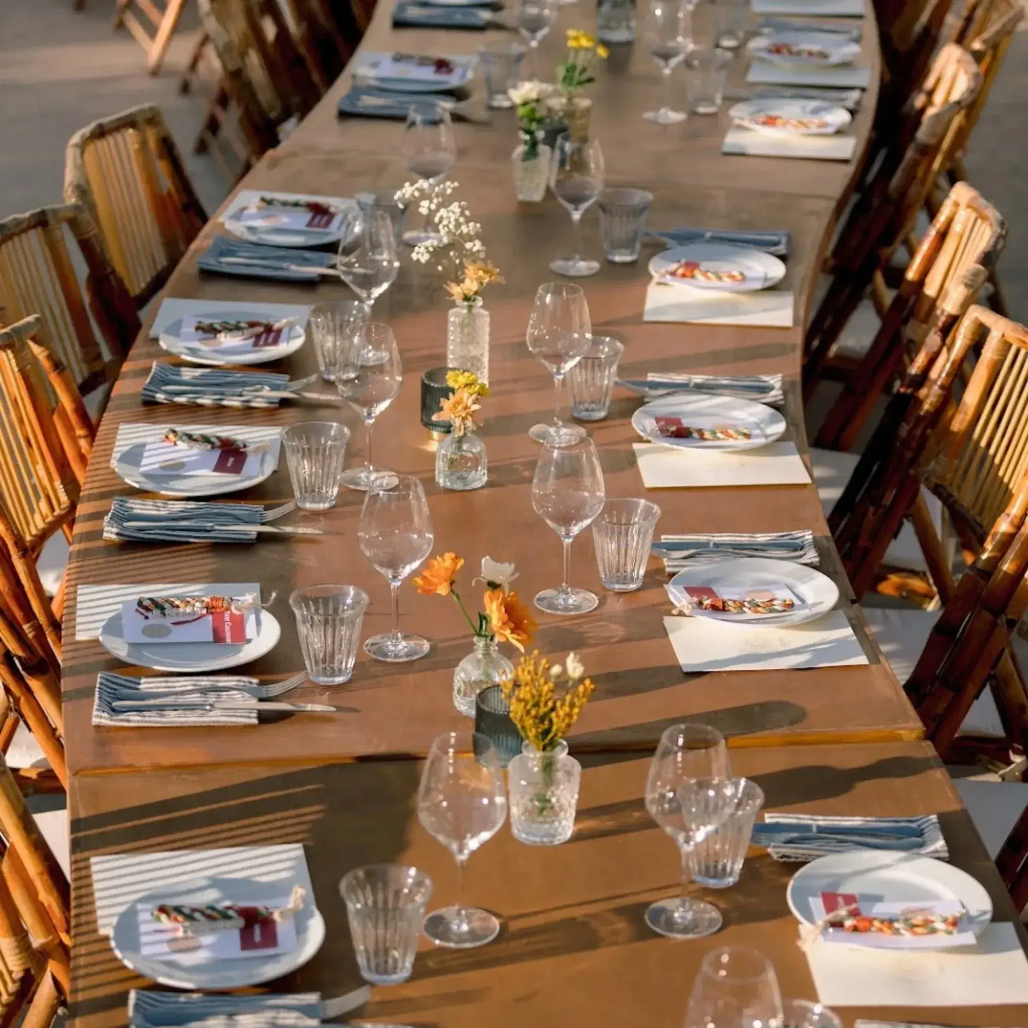 Juntos House: Long wooden table set with flowers and menus (from the 2026 wedding brochure images)