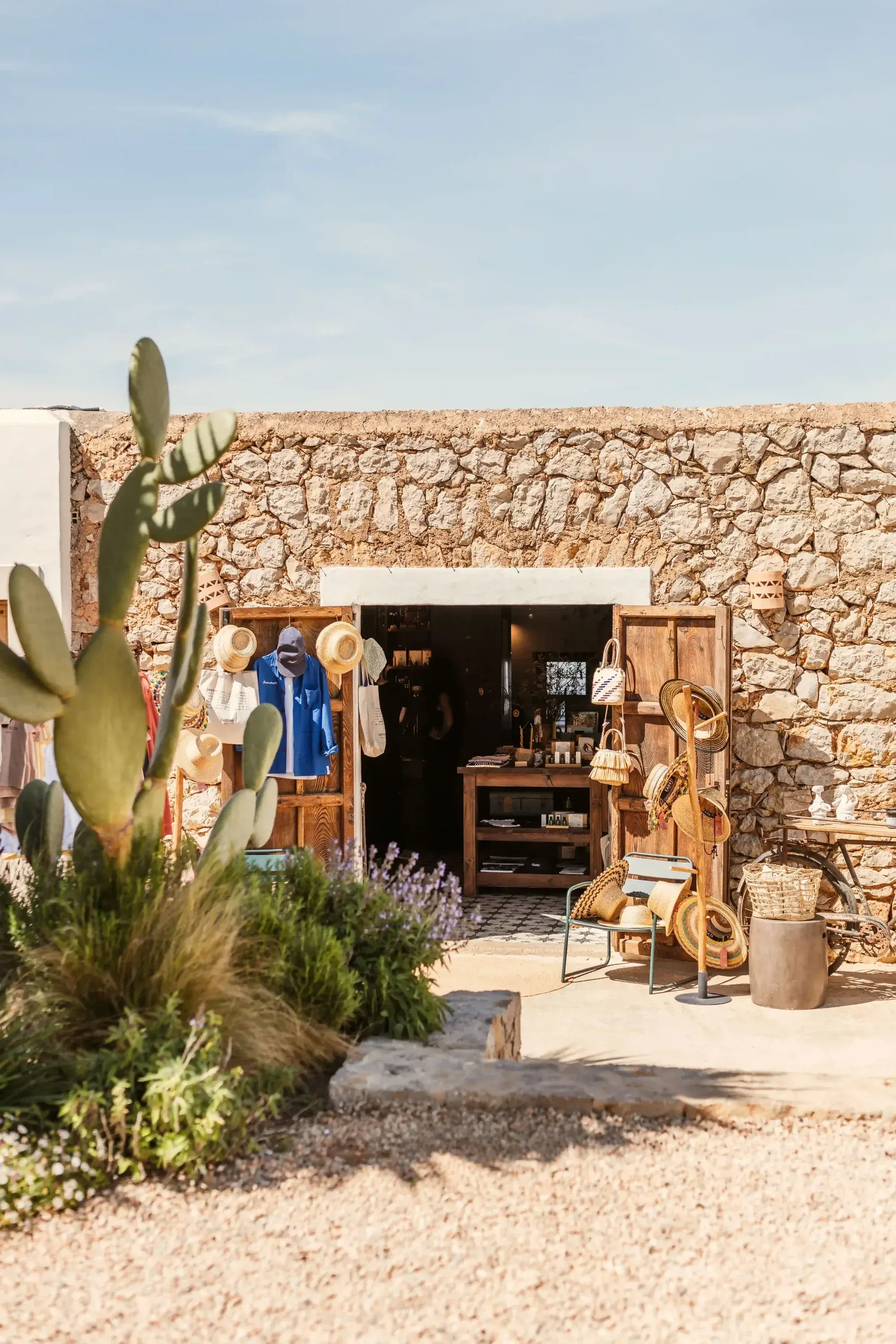 Juntos House: Stone outbuilding with cacti and gravel path