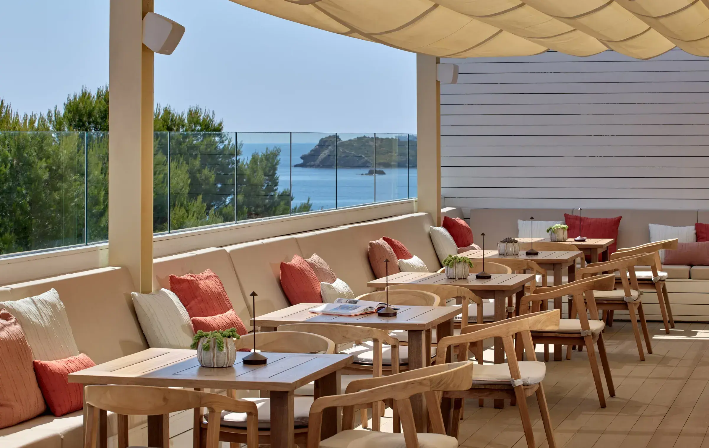 ME Ibiza: Shaded terrace restaurant with cushioned banquette and sea view