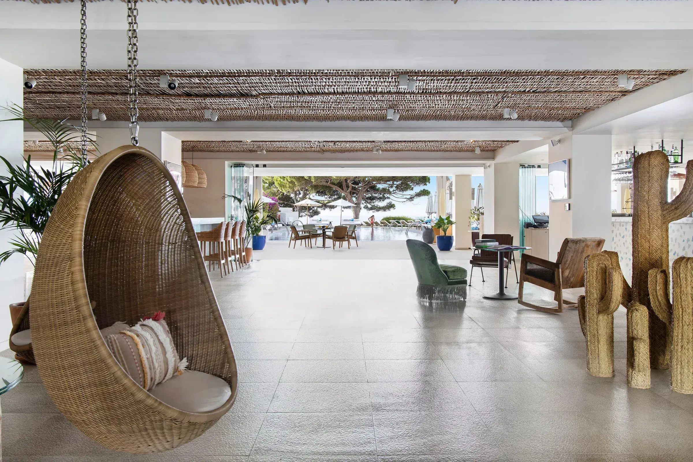 ME Ibiza: Open lobby with hanging wicker chair and cactus sculptures