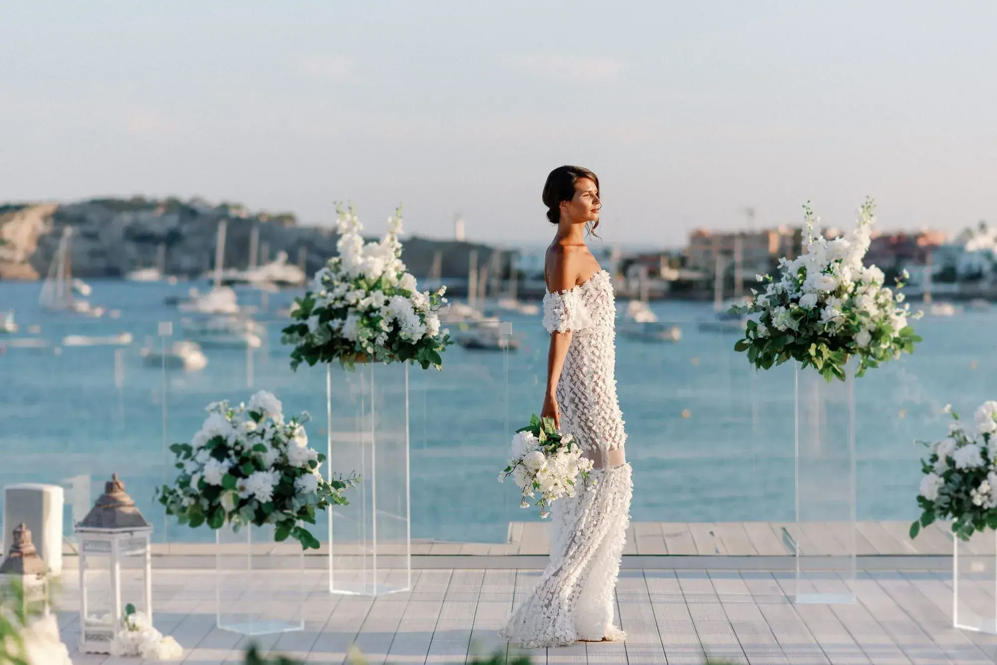Nobu Hotel Ibiza Bay: Bride on the rooftop with floral columns and boats in the bay