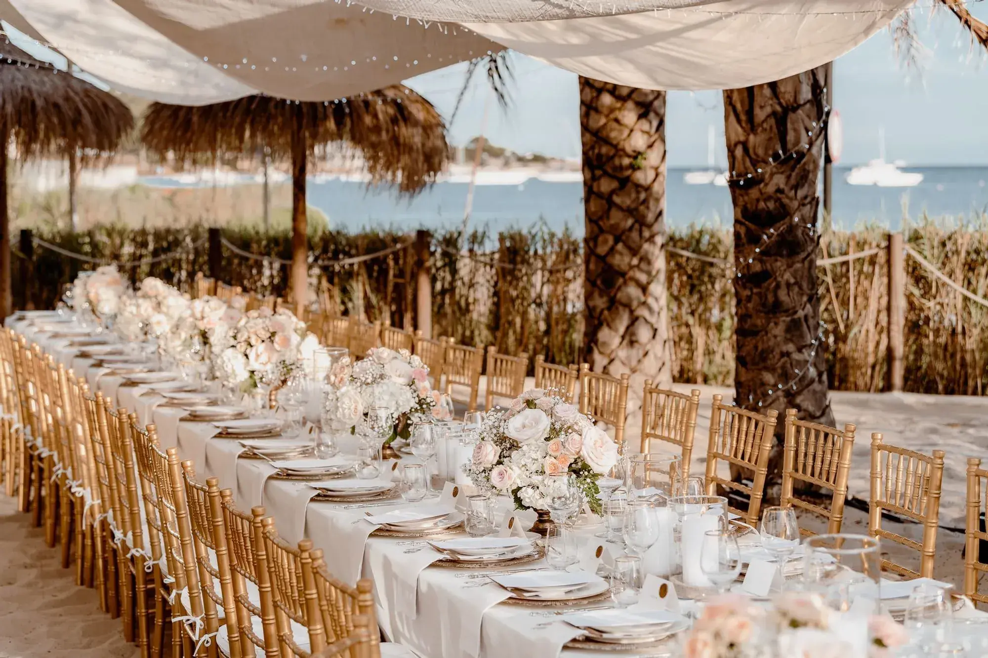 Nobu Hotel Ibiza Bay: Long wedding tables with white flowers under the beach restaurant's canopy